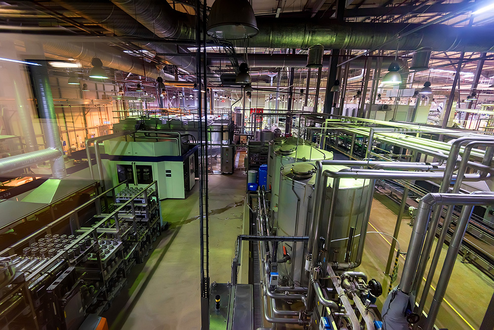 Industrial interior of soft drinks factory with tubes