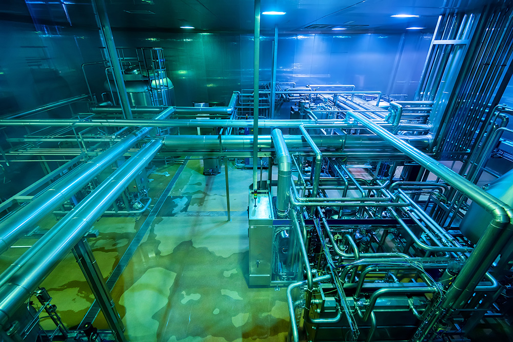 Industrial interior of soft drinks factory with tubes